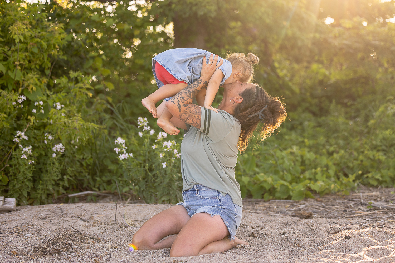 mom and daughter at a beach photoshoot during a golden hour